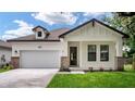 Beautiful exterior of a home with a well-maintained lawn, charming entrance and attached two-car garage at 1415 S Lincoln Ave, Lakeland, FL 33803