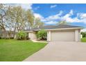 Well-manicured lawn and mature trees surround this traditional style home at 1837 Farrington Dr, Lakeland, FL 33809