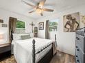 Cozy bedroom with wood floors, two windows, and neutral decor at 209 W Crescent Dr, Lakeland, FL 33805