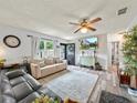 Bright living room featuring modern ceiling fan and hardwood flooring at 209 W Crescent Dr, Lakeland, FL 33805