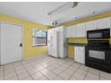 Sunlit kitchen with ample counter space, white cabinets, and modern appliances at 2173 Castle Pt, Winter Haven, FL 33880