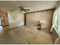 Neutral living room featuring tile flooring, ceiling fan and natural lighting at 220 Pinehurst Dr, Auburndale, FL 33823