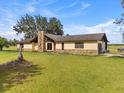 Single Gathering home featuring a stone chimney and partial stone front on a large grassy lot at 2500 Brooke Rd, Fort Meade, FL 33841