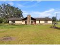 Charming single Gathering home with stone chimney and partial stone front on large grassy lot at 2500 Brooke Rd, Fort Meade, FL 33841