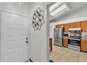 Bright kitchen with stainless steel appliances and tile floors, adjacent to the entryway at 2526 Fabry Cir, Orlando, FL 32817