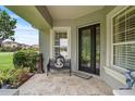 Inviting front porch with tile flooring and a comfortable bench at 2569 Laurel Glen Dr, Lakeland, FL 33803