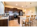 Modern kitchen features granite countertops, stainless steel appliances, and a stylish breakfast bar at 297 Spirit Landings Cir, Winter Haven, FL 33880