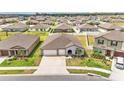This single-story home features a 2-car garage, manicured lawn, and inviting entryway, nestled in a well-planned neighborhood at 2991 Flying Blackbird Rd, Bartow, FL 33830