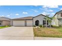 Well-maintained single-story home features a 2-car garage, manicured lawn, and inviting entryway at 2991 Flying Blackbird Rd, Bartow, FL 33830