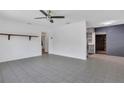 Spacious living room featuring tile floors, neutral walls and a ceiling fan at 317 S 8Th St, Haines City, FL 33844