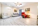 Bright living room featuring new light gray floors, a ceiling fan, and neutral walls at 3281 Enclave Blvd, Mulberry, FL 33860