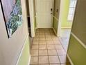 A tiled entryway with decorative trim leading to a brightly lit room at 4038 Lehman Ln, Lakeland, FL 33813