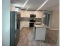 Bright kitchen featuring stainless steel appliances, light cabinets, and a functional center island at 420 S 9Th Ave, Bartow, FL 33830