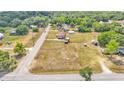Aerial view showing a mobile home and property with outbuildings and plenty of open space under a sunny sky at 4207 Ollie Rd, Lakeland, FL 33810