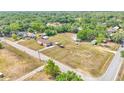 Aerial view of a mobile home on a large lot surrounded by lush greenery, with additional buildings and ample space at 4207 Ollie Rd, Lakeland, FL 33810