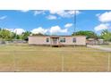 Cozy mobile home with a small front porch, set within a fenced yard under a blue sky with puffy clouds at 4207 Ollie Rd, Lakeland, FL 33810