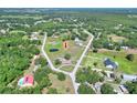 Aerial shot showcasing a home with land, highlighted with an arrow for location, among lush surroundings at 4404 Musket Dr, Lakeland, FL 33810