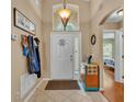 Bright foyer with high ceilings, a charming pendant light, and a glimpse into the cozy bedroom at 506 Henley Cir, Davenport, FL 33896