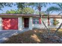 Lovely single-story home featuring a red garage door and well-maintained exterior at 526 Marklen Loop, Polk City, FL 33868