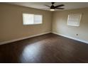 Bedroom featuring wood-look floors, a ceiling fan and window allowing for natural light at 5604 Stratford Ln, Lakeland, FL 33813