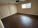 Spacious bedroom with wood-look floors, ceiling fan and bright natural light at 5604 Stratford Ln, Lakeland, FL 33813