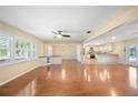 Bright living room boasts hardwood floors, large windows with natural light, and a seamless open floorplan at 5604 Stratford Ln, Lakeland, FL 33813