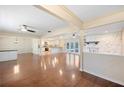 Spacious living area featuring hardwood floors, stone fireplace, and open flow to the modern kitchen at 5604 Stratford Ln, Lakeland, FL 33813
