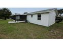 A bright back exterior with a screened in patio and a large yard at 6131 Doe E Cir, Lakeland, FL 33809