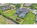 Aerial view of the property showcasing the home, pool, spacious backyard, playground, and well-maintained landscaping at 6546 Eagle View Loop, Lakeland, FL 33813