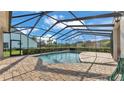 Screened-in pool featuring a brick patio and clear blue water, perfect for relaxation and outdoor enjoyment at 6546 Eagle View Loop, Lakeland, FL 33813