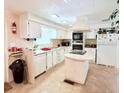 Bright kitchen with white cabinets, an island cooktop, and modern appliances at 816 Elizabeth Ln, Lakeland, FL 33809