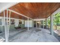 View of the covered carport showing a garage door, access to the house, and a screened-in porch at 921 Avon Ave, Lakeland, FL 33801