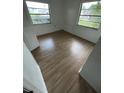 This bedroom features light wood floors and windows that provide ample natural light at 930 E Tee Cir, Bartow, FL 33830