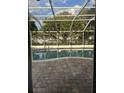 Relaxing screened-in pool with brick patio, perfect for a serene outdoor retreat at 1110 Cypress W Pt, Winter Haven, FL 33884