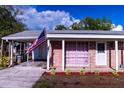 Charming brick home with a cozy carport and well-maintained landscaping and decorative touches at 1160 Eleanore Ave, Bartow, FL 33830