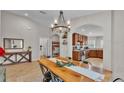 Well-lit dining area with an arched doorway to the kitchen and stylish decor at 1215 Evergreen Park Cir, Lakeland, FL 33813
