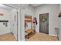 Inviting entryway with a coat rack, bench, and tile flooring at 1215 Evergreen Park Cir, Lakeland, FL 33813