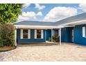 Beautiful blue single-story home featuring a brick driveway and covered carport at 1328 Edgewater Beach Dr, Lakeland, FL 33805