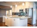 Bright, remodeled kitchen with white cabinets, stainless steel appliances, and granite countertops at 1328 Edgewater Beach Dr, Lakeland, FL 33805