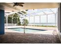 Enjoy the screened pool with a serene lake view, creating a perfect outdoor oasis at 1328 Edgewater Beach Dr, Lakeland, FL 33805