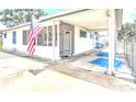 Exterior angle of the home showing an open and covered carport with concrete pad at 1405 Clinton St, Bartow, FL 33830