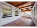 View of the covered porch featuring mosaic tile floors and natural wood ceiling at 1507 Holly Rd, Lakeland, FL 33801