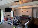 Bright living room with white-painted brick fireplace, wood beams and neutral walls at 208 Center St, Auburndale, FL 33823
