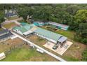 Expansive aerial shot of the property showcasing a unique home layout, large yard, and detached garages at 2219 New Jersey Rd, Lakeland, FL 33803