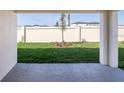 View of the backyard featuring green grass and a privacy fence at 2331 Northumberland Ct, Haines City, FL 33844