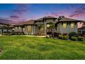 An inviting two-story home with a manicured lawn, flower beds, and decorative trees at 2662 Delphi Hills Ct, Lakeland, FL 33812