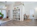 Inviting foyer with stylish décor, glass cabinet and a dedicated workspace near the front door at 3873 Hampton Hills Dr, Lakeland, FL 33810