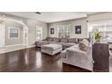 Spacious living room with dark hardwood floors, ample natural light, and a comfortable oversized sectional sofa at 402 W Patterson St, Lakeland, FL 33803