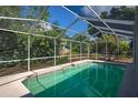 Screened-in pool provides a refreshing escape in a private backyard setting with lush landscaping at 402 W Patterson St, Lakeland, FL 33803