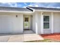 Welcoming entrance showcasing a bright yellow framed door, white trim, and clean, modern exterior design at 404 Willow Run, Lakeland, FL 33813